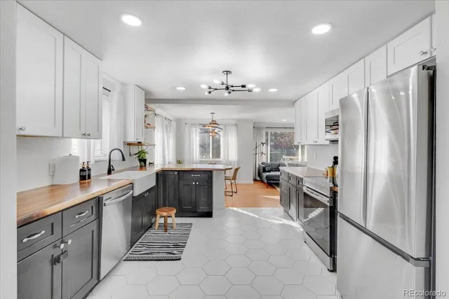 a kitchen with stainless steel appliances a refrigerator sink and cabinets