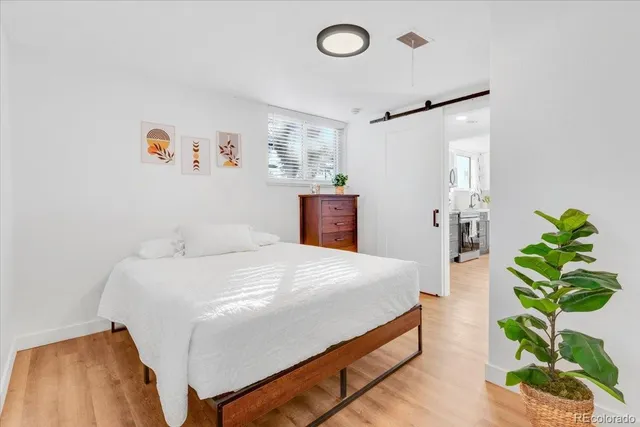 a bedroom with bed and a potted plant