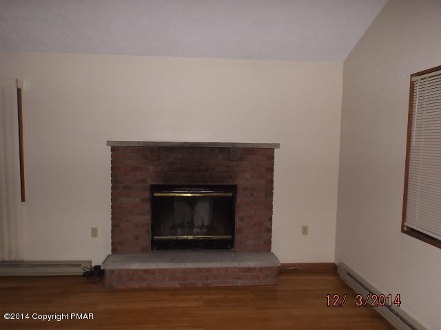 833 Canterbury Road Bushkill, PA 18324 - Photo 5 of 9 a living room with a fireplace