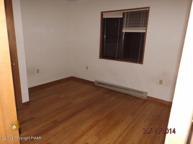 833 Canterbury Road Bushkill, PA 18324 - Photo 7 of 9 an empty room with wooden floor