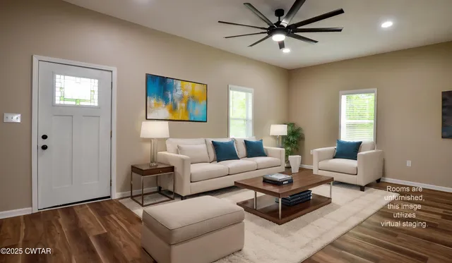 a living room with furniture a view of bedroom and a window