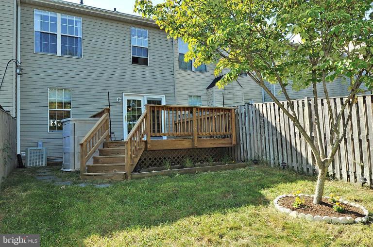 6116 Starburn Path Columbia, MD 21045 - Photo 13 of 18 a front view of a house with a yard