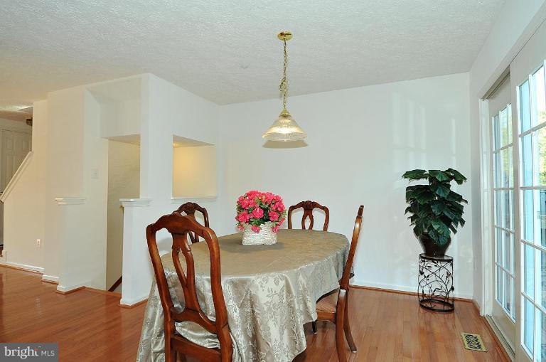 6116 Starburn Path Columbia, MD 21045 - Photo 16 of 18 a view of a dining room with furniture window and wooden floor