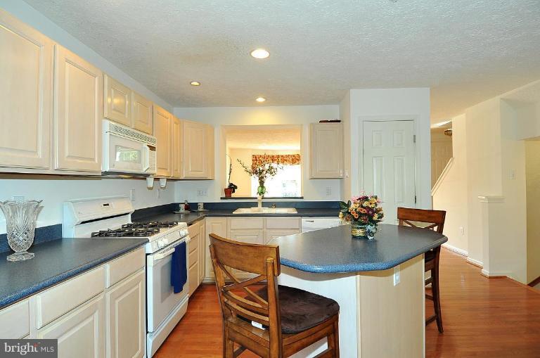 6116 Starburn Path Columbia, MD 21045 - Photo 4 of 18 a kitchen with a sink a stove a counter space and cabinets