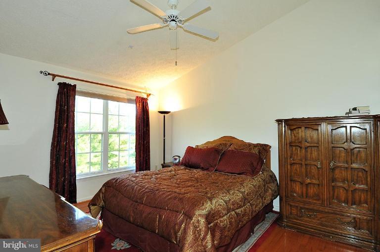 6116 Starburn Path Columbia, MD 21045 - Photo 5 of 18 a bedroom with a bed window and wall painting