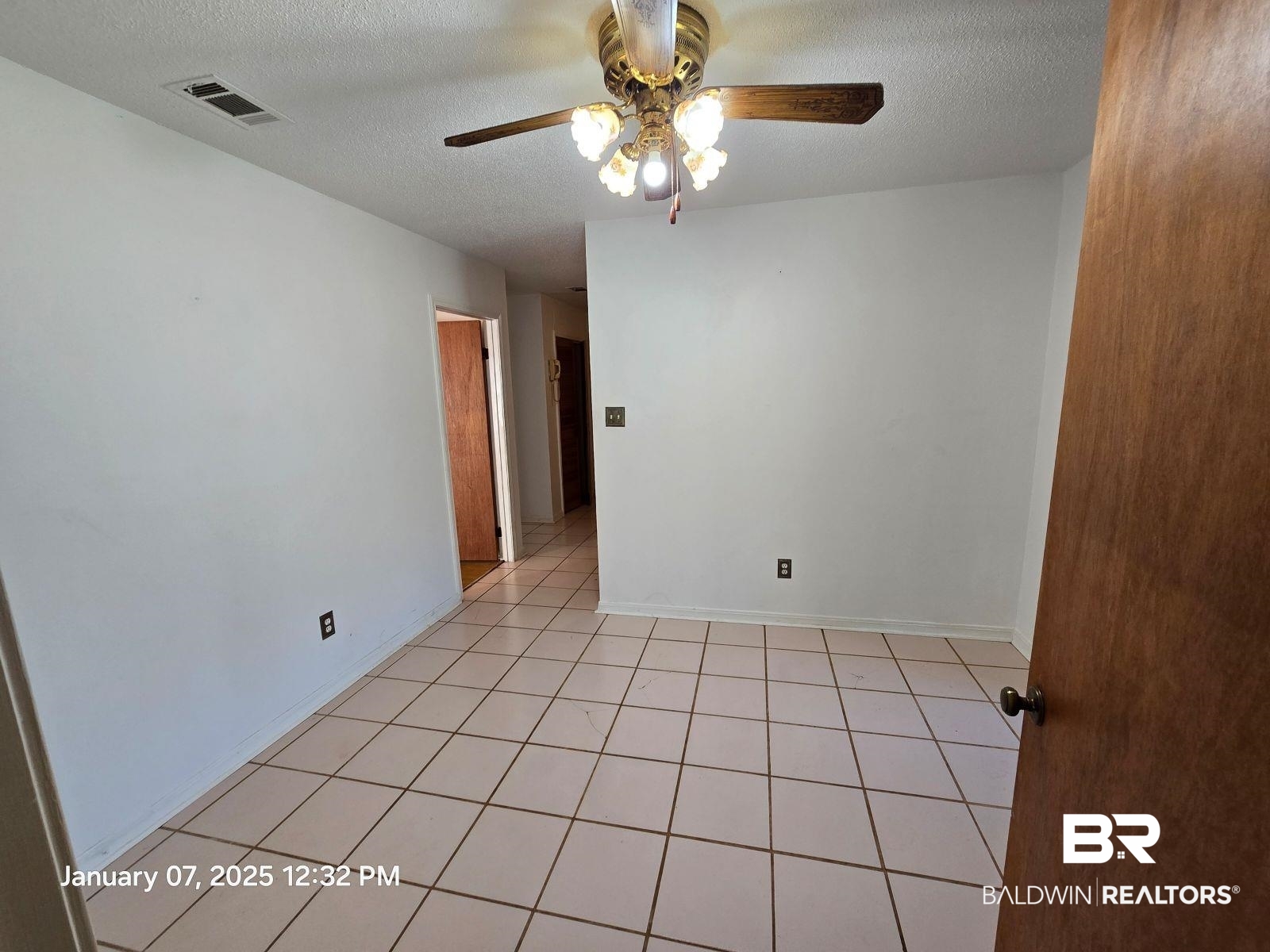 154 Byrd Road Monroeville, AL 36460 - Photo 10 of 26 Spare room featuring ceiling fan, a textured ceiling, and light tile patterned flooring
