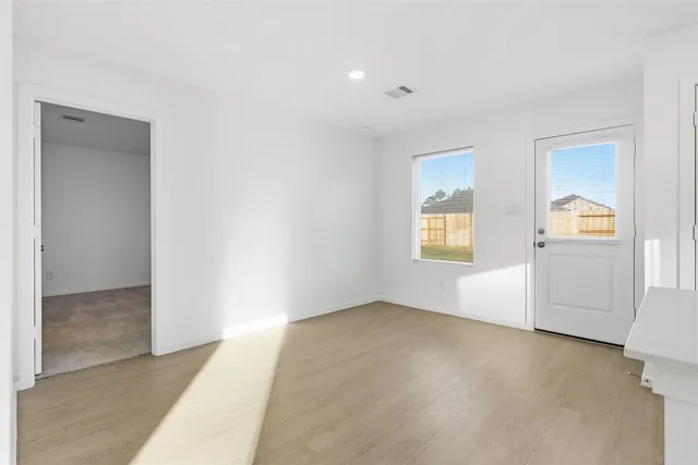 an empty room with windows and closet