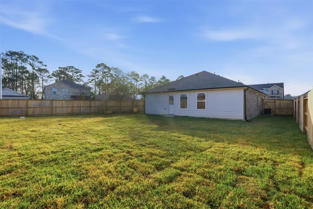 a large pool with lawn chairs and a yard