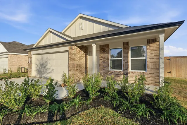 a view of a house with a small yard and plants