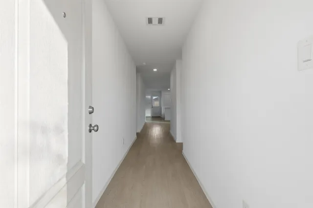 a view of a hallway with wooden shelves