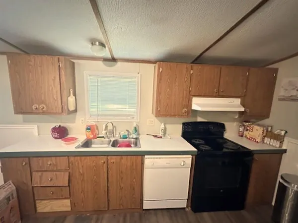 a kitchen with stainless steel appliances a refrigerator and wooden cabinets