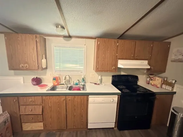 a kitchen with stainless steel appliances a refrigerator and wooden cabinets