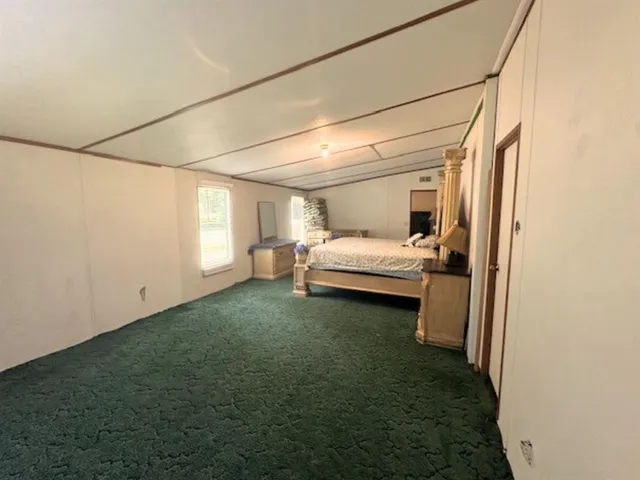 a view of a livingroom with furniture and a window