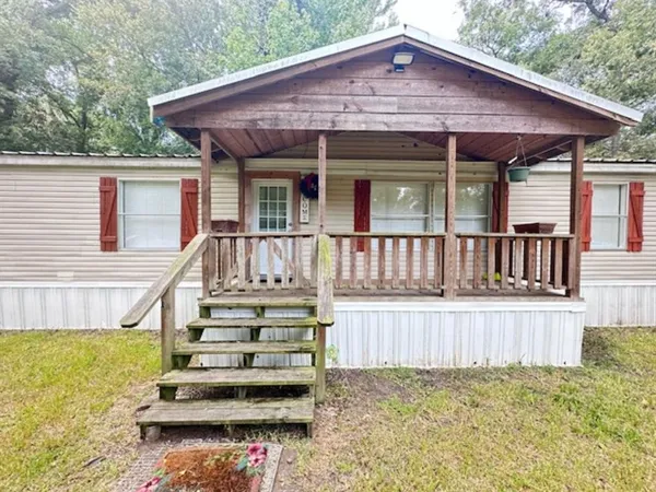 a view of a house with wooden floor and a yard