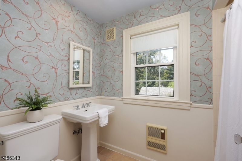 15 Georgian Road Morristown, NJ 07960 - Photo 25 of 44 a bathroom with a sink a toilet and a mirror