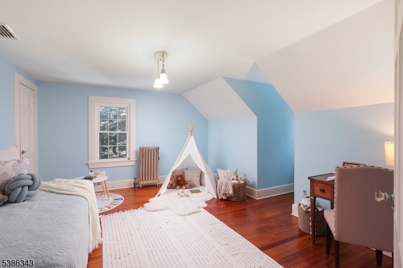 15 Georgian Road Morristown, NJ 07960 - Photo 28 of 44 a bedroom with a bed and a chandelier