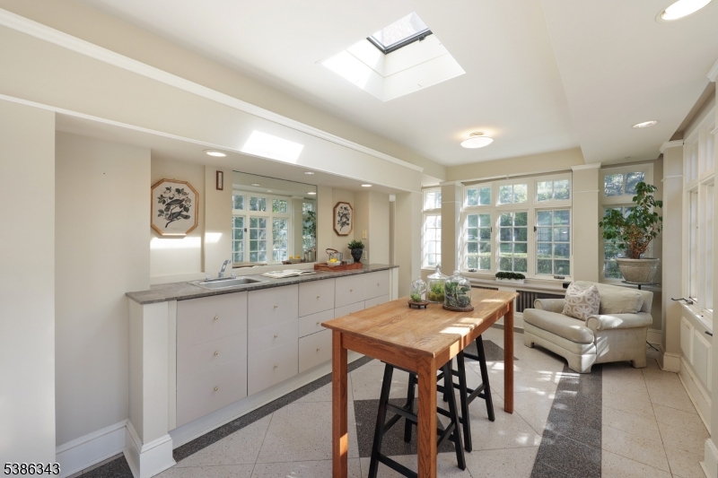 15 Georgian Road Morristown, NJ 07960 - Photo 8 of 44 a dining hall with couches a coffee table and chairs with wooden floor