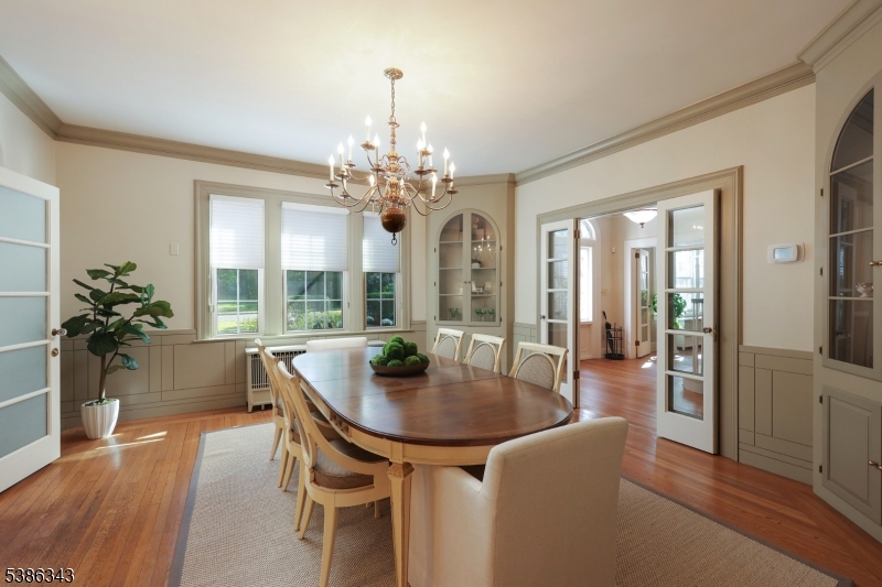 15 Georgian Road Morristown, NJ 07960 - Photo 10 of 44 a dining room with furniture wooden floor a potted plant and a chandelier