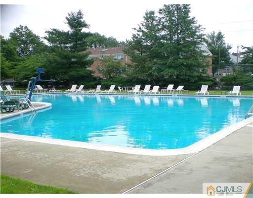 197 Evergreen Road, Unit 12B Edison, NJ 08837 - Photo 6 of 8 a view of a swimming pool with a yard