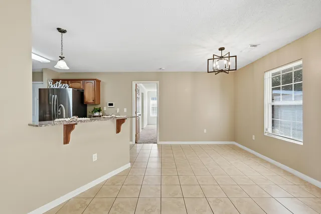 a view of a living room and chandelier fan