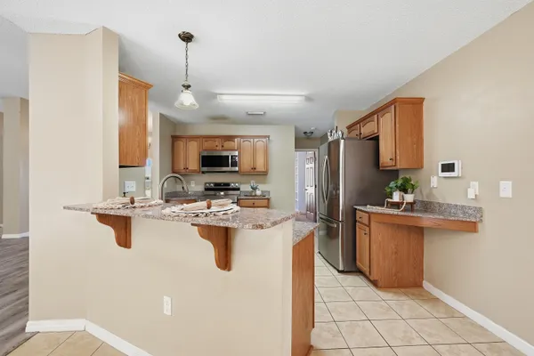 a kitchen with a sink appliances and cabinets