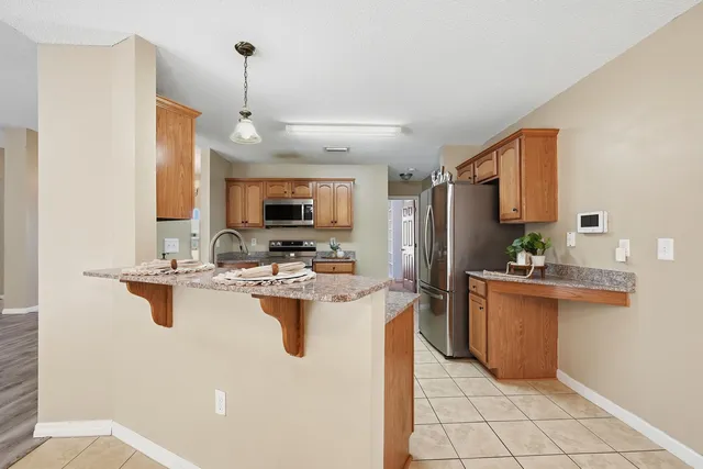 a kitchen with a sink appliances and cabinets