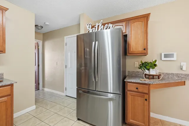 a white refrigerator freezer sitting in a kitchen