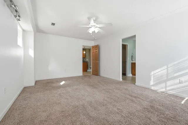 a view of a livingroom with a ceiling fan and window
