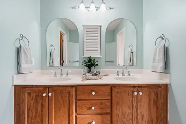a bathroom with a double vanity sink and a mirror