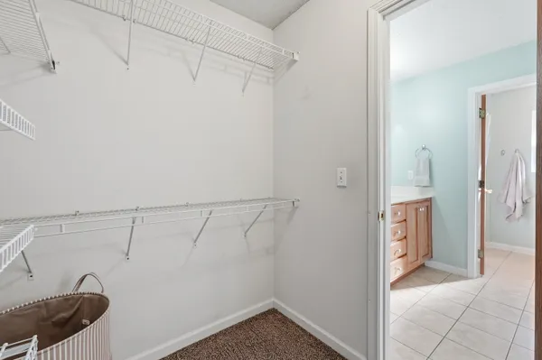 a view of walk in closet with empty racks