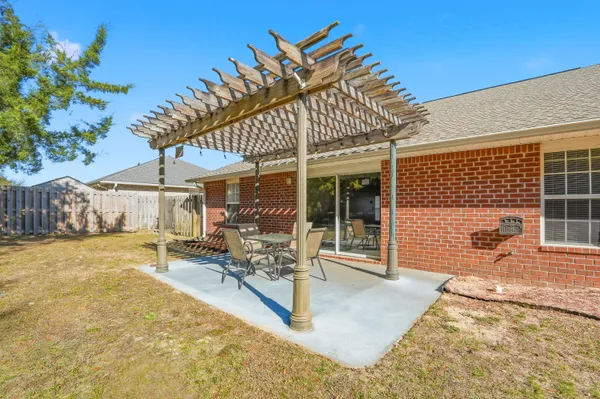 a view of a house with backyard and sitting area