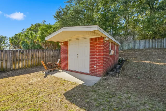 a backyard of a house with table and chairs