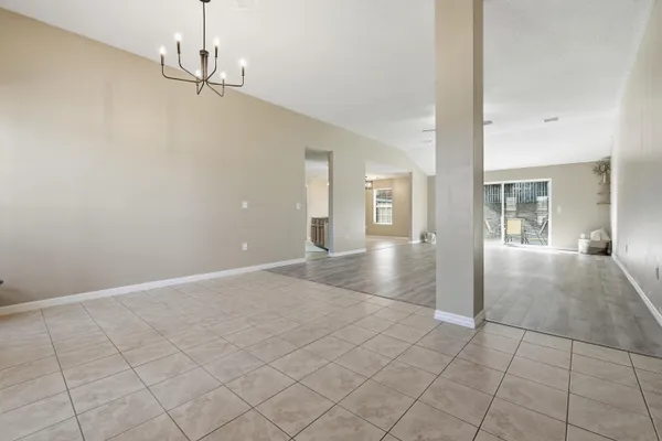 a view of a hallway with chandelier and entryway