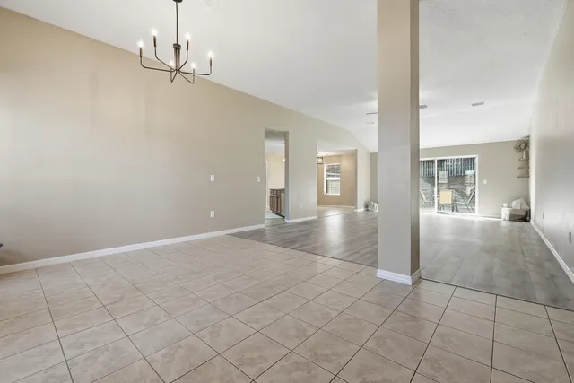 a view of a hallway with chandelier and entryway