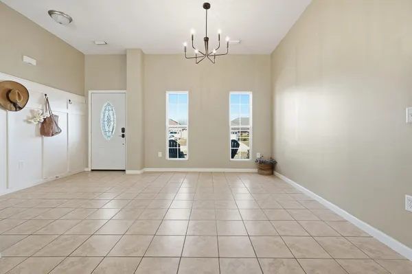 an empty room with windows and entrance