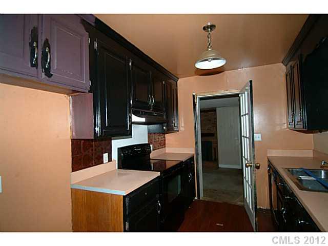 309 Culpepper Street Monroe, NC 28112 - Photo 6 of 9 a kitchen with kitchen island a counter top space appliances and cabinets