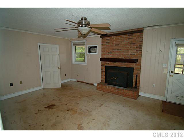 309 Culpepper Street Monroe, NC 28112 - Photo 7 of 9 a view of empty room with a fireplace