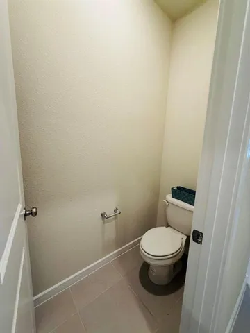 a white toilet sitting next to a shower