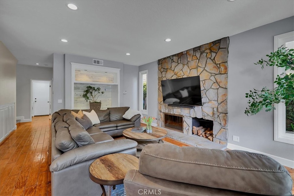 22 Colonial Irvine, CA 92620 - Photo 12 of 47 a living room with furniture a flat screen tv and a fireplace