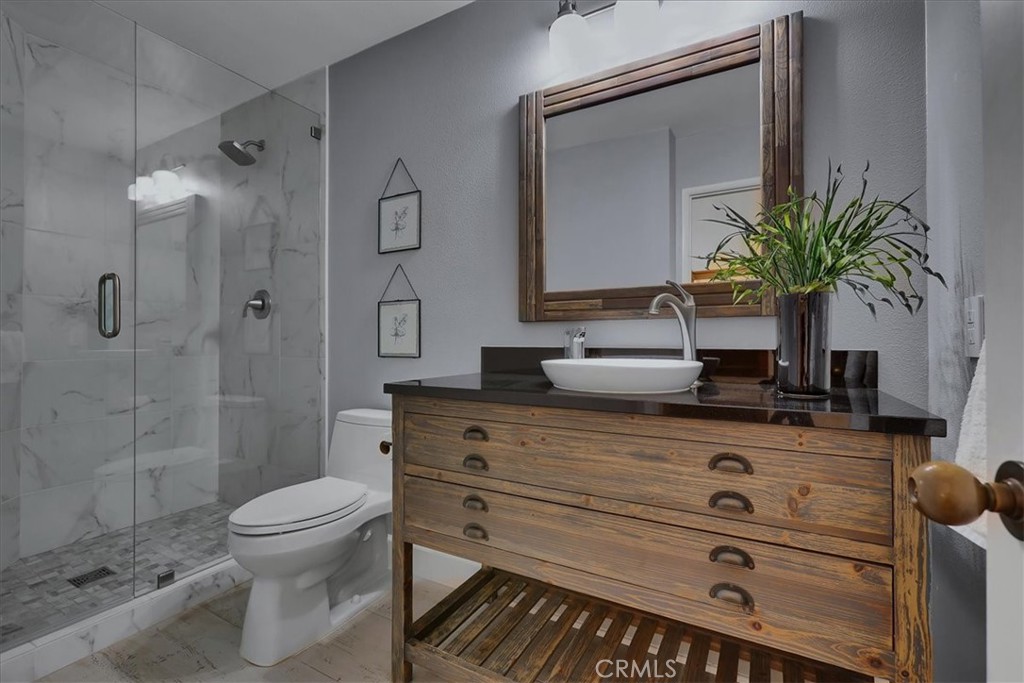 22 Colonial Irvine, CA 92620 - Photo 20 of 47 a bathroom with a granite countertop sink a toilet and shower