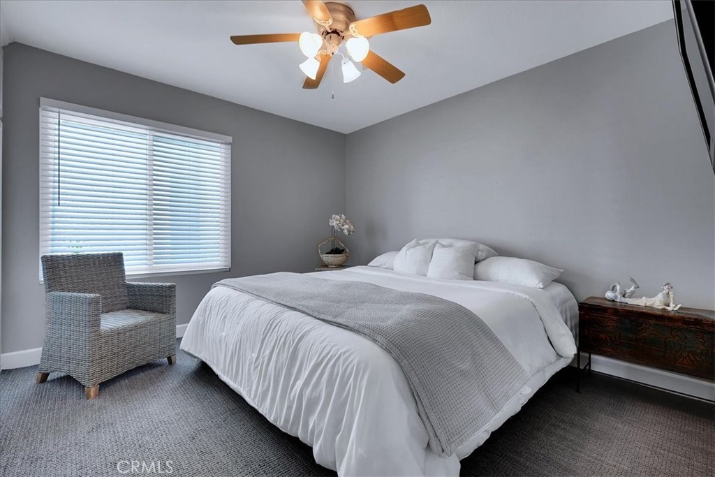 22 Colonial Irvine, CA 92620 - Photo 28 of 47 a bedroom with a bed and a chandelier