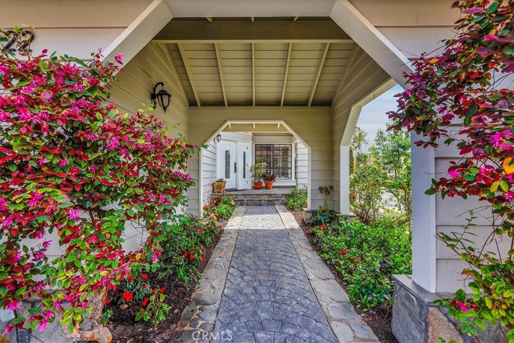 22 Colonial Irvine, CA 92620 - Photo 3 of 47 a front view of a house with lots of flowers around