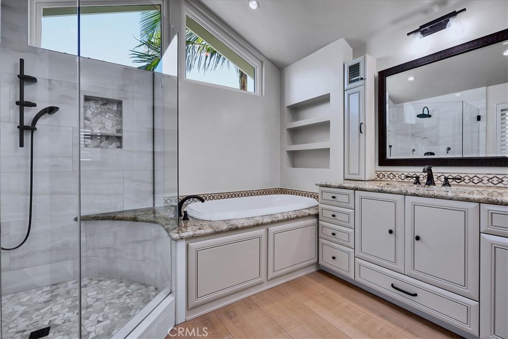22 Colonial Irvine, CA 92620 - Photo 38 of 47 a bathroom with a granite countertop sink a mirror and a shower