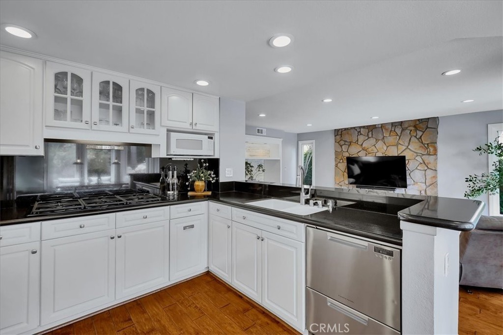 22 Colonial Irvine, CA 92620 - Photo 9 of 47 a kitchen with granite countertop a sink stainless steel appliances and cabinets
