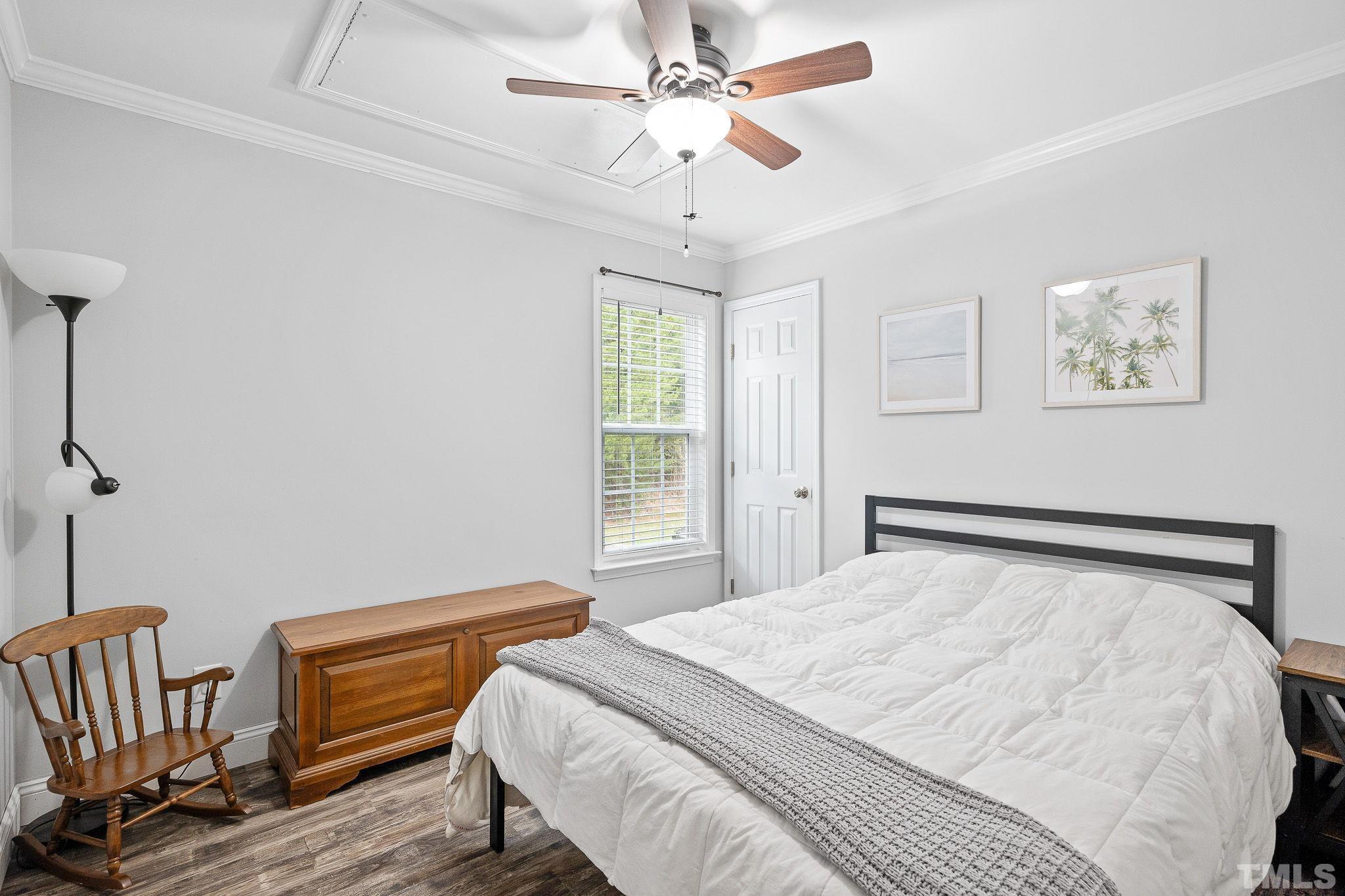 7405 Buckingham Mountain Road Snow Camp, NC 27349 - Photo 15 of 26 a bedroom with a bed and wooden floor