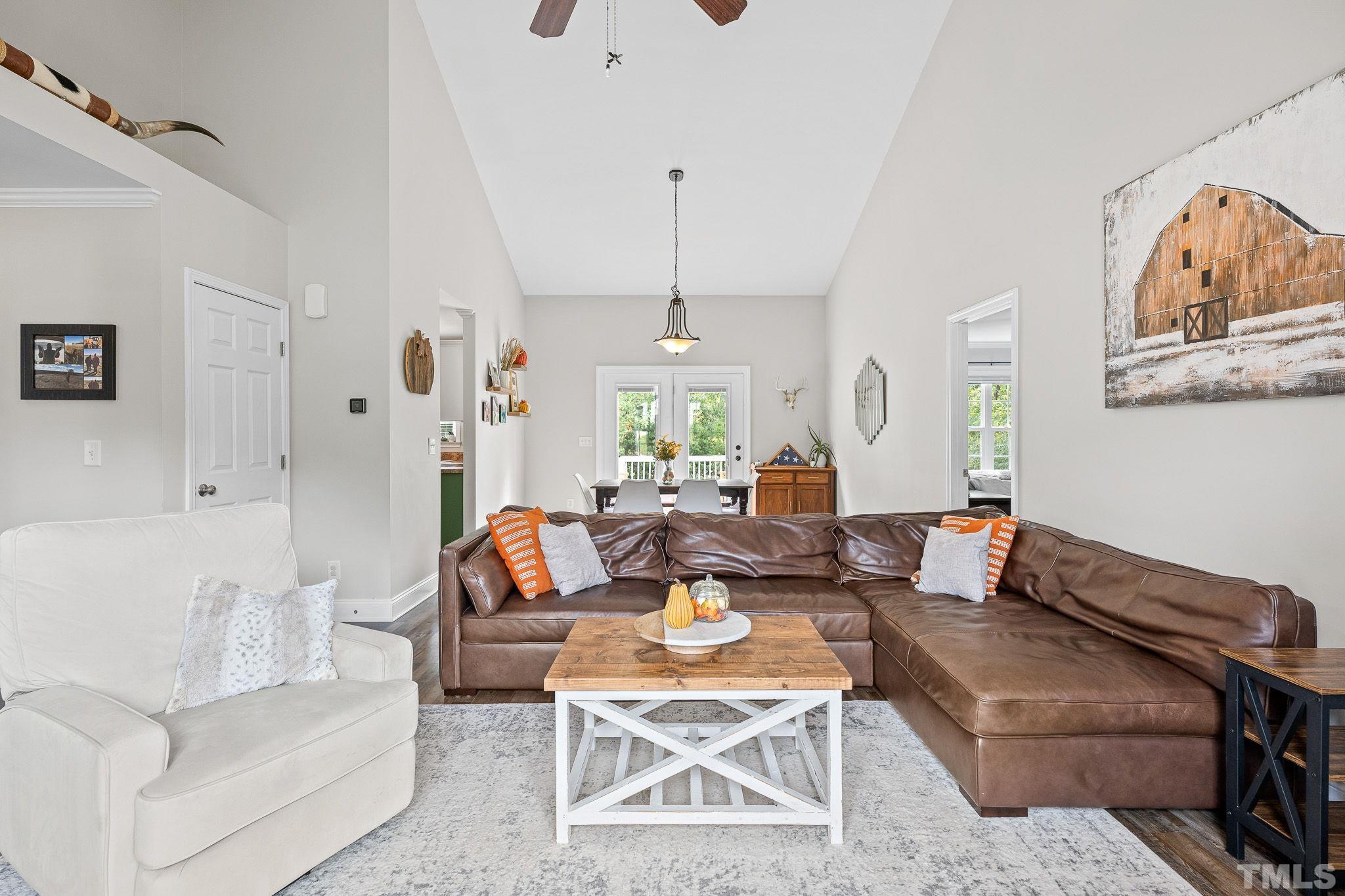 7405 Buckingham Mountain Road Snow Camp, NC 27349 - Photo 26 of 26 a living room with furniture and a chandelier