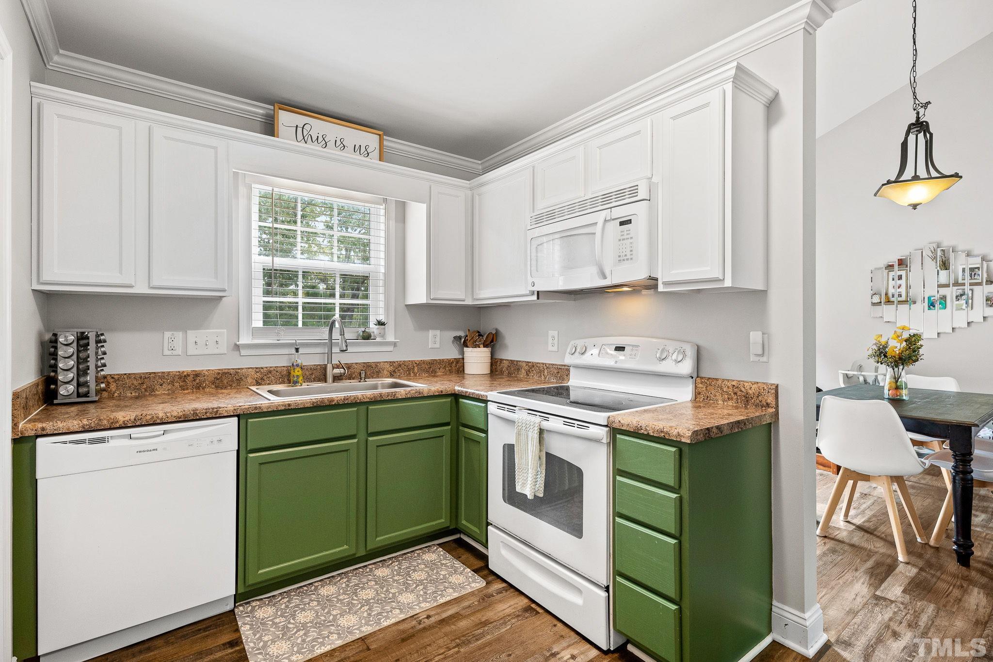 7405 Buckingham Mountain Road Snow Camp, NC 27349 - Photo 8 of 26 a kitchen with a sink stove and cabinets