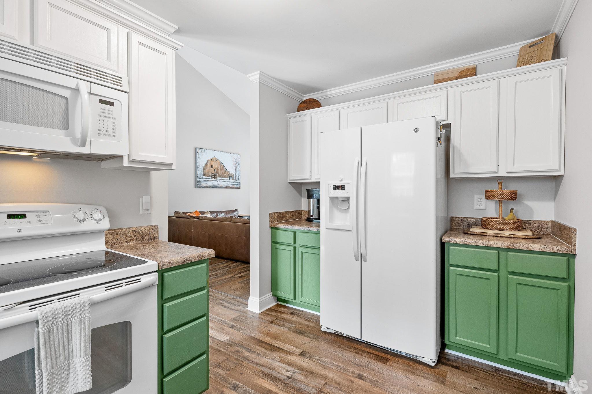 7405 Buckingham Mountain Road Snow Camp, NC 27349 - Photo 9 of 26 a kitchen with a refrigerator and a stove top oven
