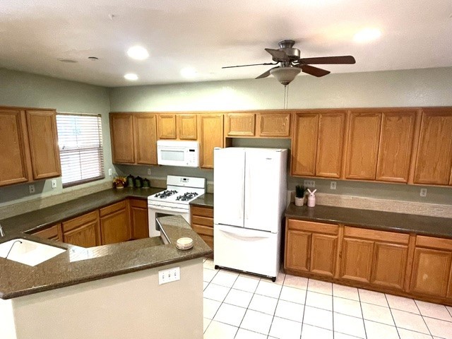8692 East 9th Street, Unit 56 Rancho Cucamonga, CA 91730 - Photo 11 of 34 a kitchen with a refrigerator cabinets and a sink
