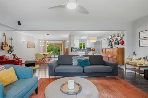 a living room with furniture and a wooden floor
